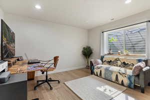 Home office with visible vents, recessed lighting, wood finished floors, and baseboards