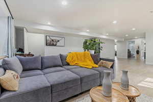 Living area with recessed lighting, wood finished floors, and baseboards