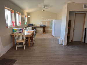 Dining space with visible vents, lofted ceiling, a ceiling fan, and light wood finished floors