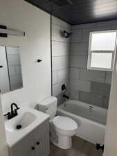 Bathroom featuring shower / bath combination, visible vents, wood finished floors, vanity, and toilet