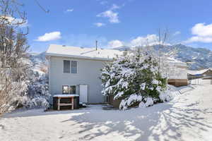 Snow covered property featuring a deck with mountain view