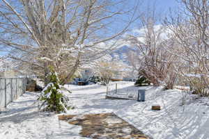 Yard layered in snow with fence