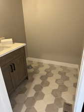 Bathroom with visible vents, baseboards, and vanity