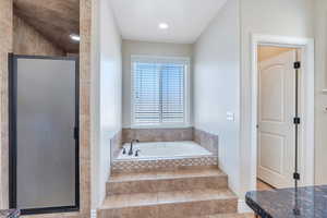Full bathroom with vanity, a garden tub, and a shower stall