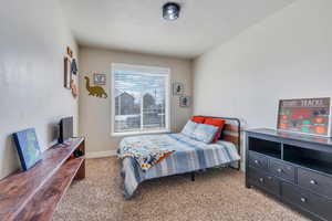 Carpeted bedroom featuring baseboards