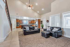 Living area featuring stairway, baseboards, visible vents, and light tile patterned flooring