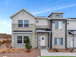 Multi unit property featuring stone siding and stucco siding