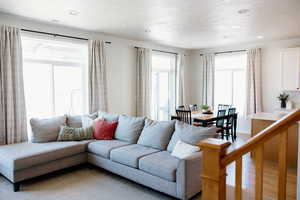 Living room featuring light wood-style flooring and recessed lighting