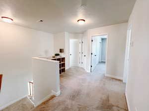 Upstairs landing with light carpet and easy access to all bedrooms