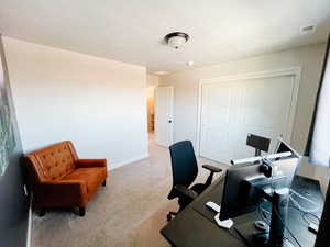 Office space/Bedroom 1 with large closet light carpet