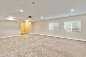 Carpeted empty room with visible vents, recessed lighting, and baseboards