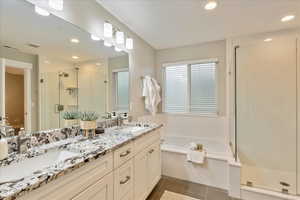 Full bath with a sink, visible vents, a stall shower, and tile patterned floors