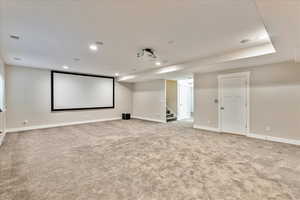 Cinema with light carpet, visible vents, recessed lighting, and baseboards