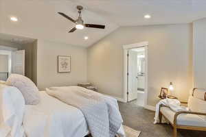 Bedroom with baseboards, dark carpet, lofted ceiling, recessed lighting, and a ceiling fan