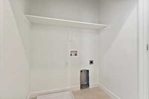 Clothes washing area featuring baseboards, hookup for an electric dryer, washer hookup, and laundry area