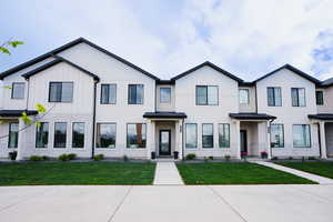 Multi unit property with board and batten siding and a front lawn