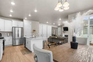 Interior space with recessed lighting, a notable chandelier, light wood-style floors, and a fireplace