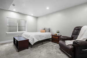 Bedroom with light carpet, visible vents, recessed lighting, and baseboards