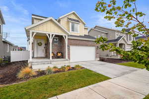 View of front of home with cooling unit, fence, brick siding, concrete driveway, and board and batten siding