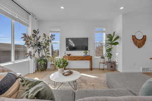 Living room featuring plenty of natural light, recessed lighting, and visible vents