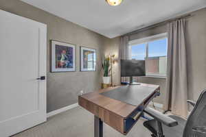 Carpeted home office featuring baseboards and visible vents