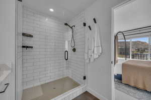 Ensuite bathroom featuring recessed lighting, baseboards, a stall shower, and ensuite bathroom