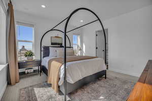 Carpeted bedroom featuring recessed lighting and baseboards