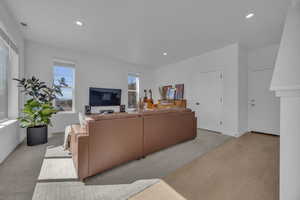 Living room with recessed lighting, visible vents, and baseboards