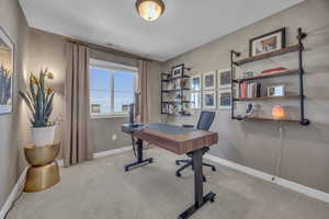 Office space featuring visible vents, baseboards, and carpet