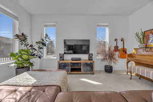 Living area with carpet flooring and baseboards