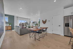 Dining room featuring recessed lighting, baseboards, and light wood-style floors