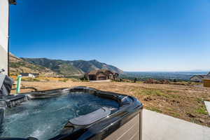 View of yard with a mountain view and a hot tub