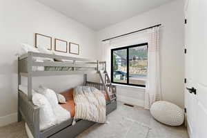 Carpeted bedroom featuring visible vents and baseboards