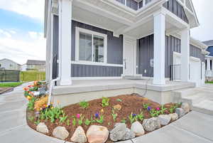 Property entrance with board and batten siding and a porch