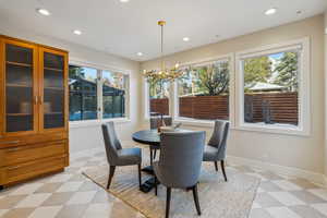 Dining area featuring an inviting chandelier, recessed lighting, light floors, and baseboards