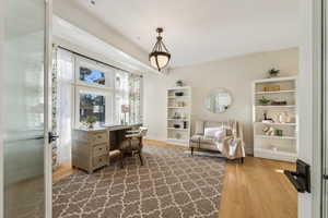 Home office with baseboards and wood finished floors