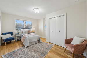 Bedroom featuring a closet, baseboards, and light wood-style flooring