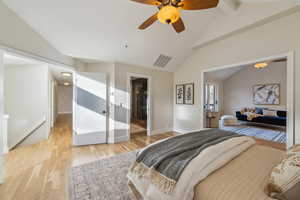 Bedroom with visible vents, ceiling fan, baseboards, light wood-type flooring, and lofted ceiling