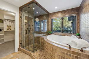Full bath with tile patterned floors, recessed lighting, a stall shower, and a garden tub