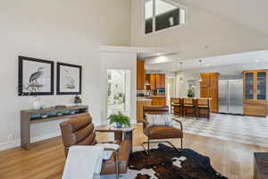 Living area with recessed lighting, baseboards, and light wood-style floors