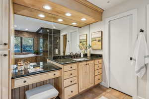 Bathroom with tile patterned floors, recessed lighting, vanity, and a shower stall
