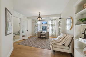 Sitting room with wood finished floors and baseboards