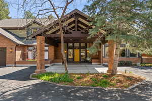 View of front of property with brick siding and roof with shingles