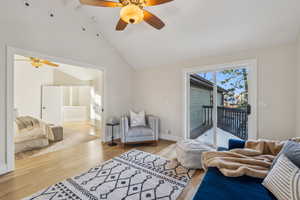 Living room featuring baseboards, lofted ceiling, light wood-style floors, and ceiling fan