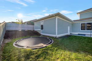 View of side of property with a trampoline