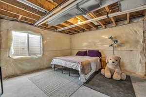 Bedroom featuring concrete flooring