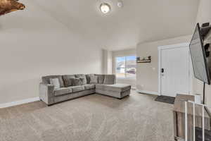 Carpeted living area with baseboards