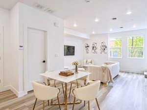Dining space with light wood-type flooring, baseboards, recessed lighting, and visible vents
