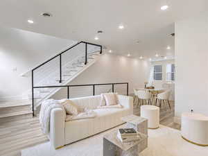 Living room with recessed lighting, stairway, visible vents, and baseboards