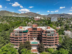 Drone / aerial view of a mountain backdrop and apartment complex